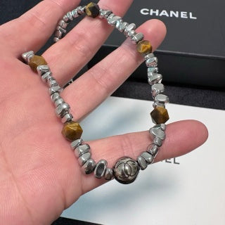 Chunky necklace featuring tiger's eye, silver beads, and crushed silver elements.