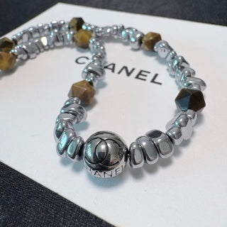 Chunky necklace featuring tiger's eye, silver beads, and crushed silver elements.